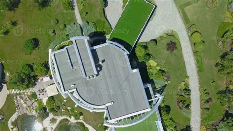 Top View Of Country Mansion Surrounded By Garden With Green Lawns And