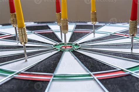 Red And Yellow Dart Arrows Hitting In The Target Center Of Dartboard