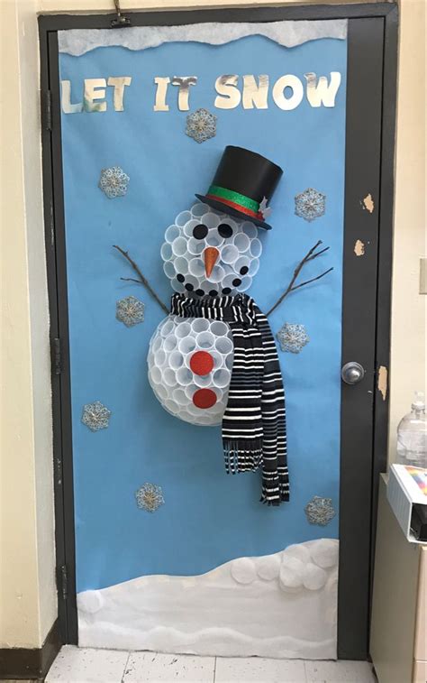 A Door Decorated With A Snowman Wearing A Top Hat And Scarf