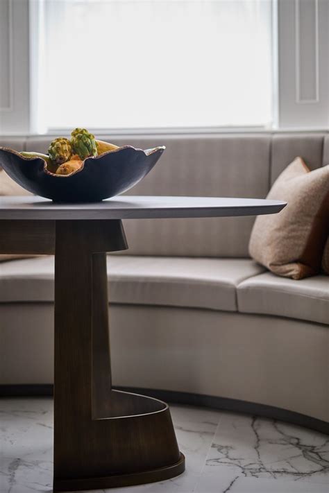 A Bowl Filled With Food Sitting On Top Of A Wooden Table Next To A Couch