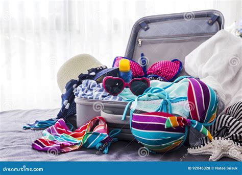 Colorful Bikini And Clothes In Luggage On The Bed Stock Photo Image Of Copy Clothes