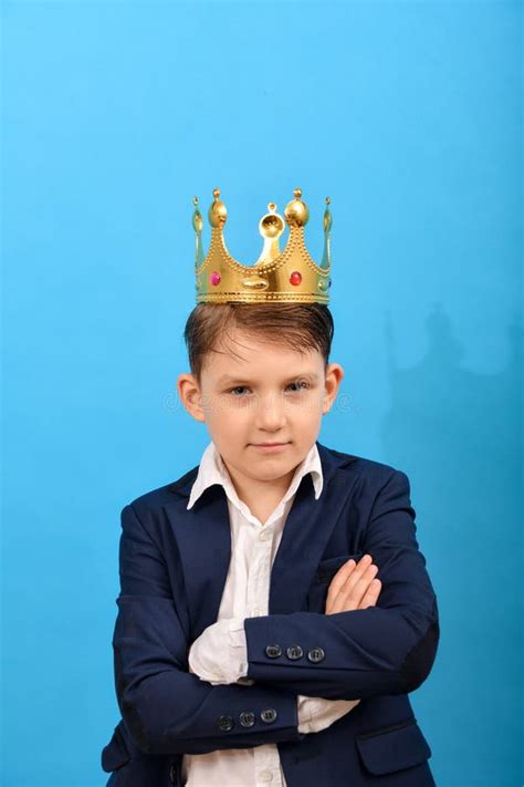 A Boy With A Crown On His Head Holds Bundles Of 100 200 And 500 Euro