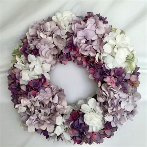 A Wreath Made Out Of Purple And White Flowers