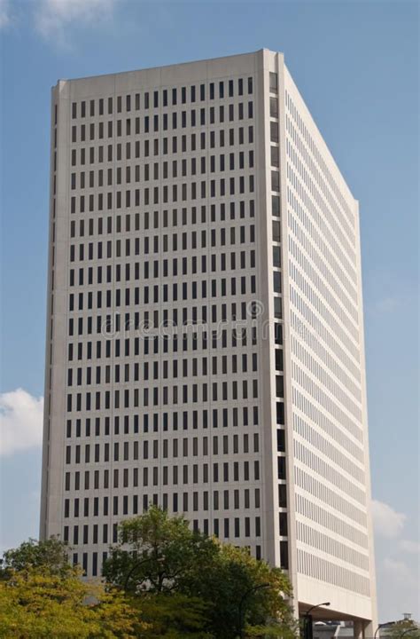 A Tall White Building With Lots Of Windows