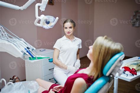 Beuatiful Female Dentist Posing And Smiling With Her Lovely Patient