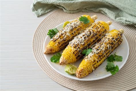 Premium Photo | Barbecue and grilled corn with cheese and lime