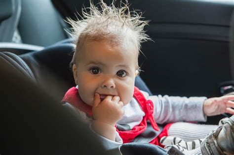 Premium Photo Baby With Wet Hair After The Rain Sitting In A Car