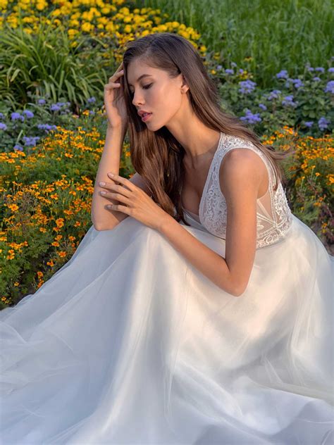 A Line Wedding Dress With A Deep V Neckline Lace Bodice And Illusion Back