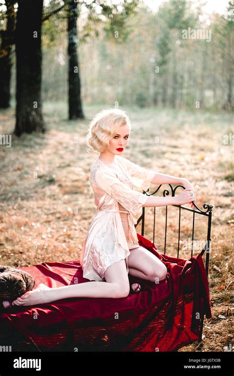 Beautiful And Elegant Blonde Woman With Red Lips And Hair Waves Wearing