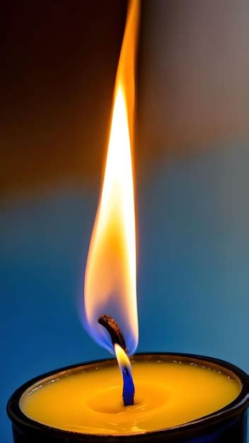 Premium AI Image | Burning candle in blue and yellow tones captured in ...