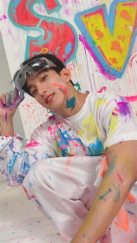 A Boy With Paint All Over His Face Sitting On The Ground