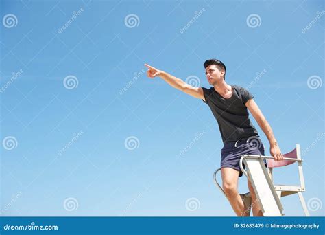 Male Lifeguard Pointing Into The Distance Stock Image Image Of