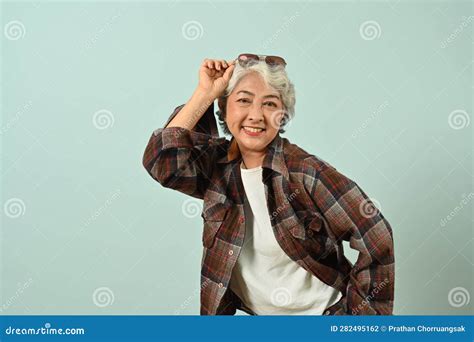 Portrait Of Happy Mature Woman Wearing Plaid Shirt Posing Isolated On
