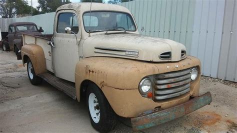 Old Ford Truck Parked in Front of Metal Building