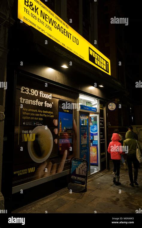 Western Union Money Transfer And Paypoint Signage And Logo At Night