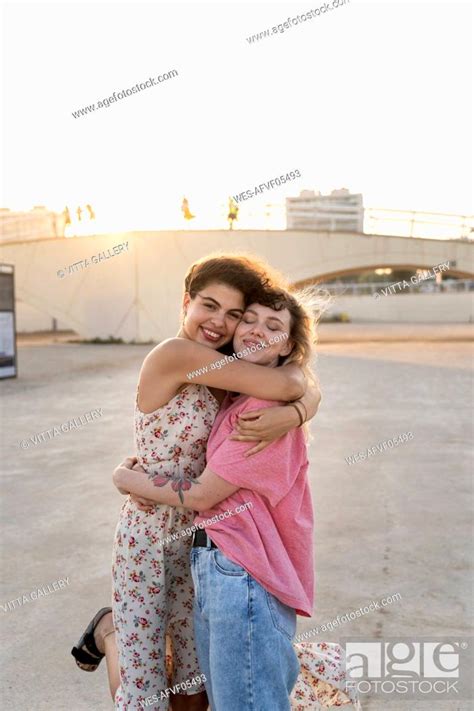 Happy friends hugging outdoors at sunset, Stock Photo, Picture And ...