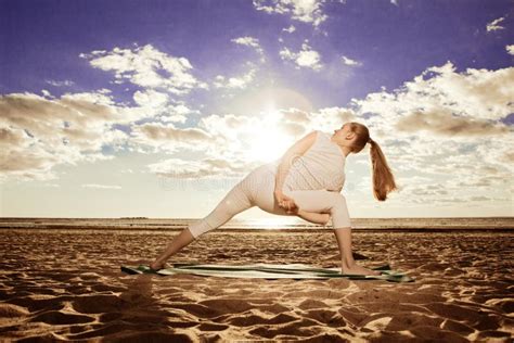 Young Beautiful Slim Woman Practices Yoga On The Beach At Sunset Stock Image Image Of Pose