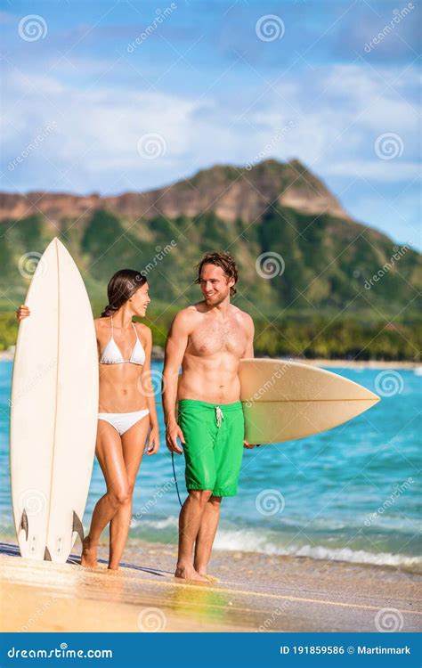 Beach Couple Surfing In Hawaii Relaxing At Sunset Standing With