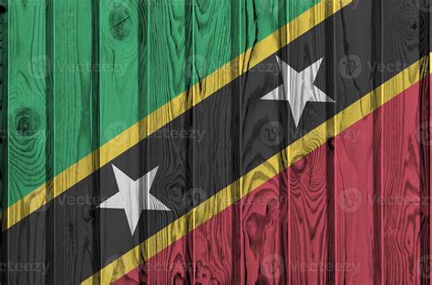 Saint Kitts And Nevis Flag Depicted In Bright Paint Colors On Old