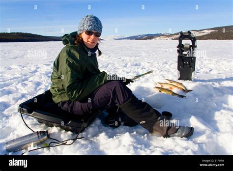 Young woman ice-fishing, Fox Lake, Yukon Territory, Canada, North America Stock Photo - Alamy