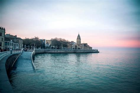 Premium Photo | Gijon beach at dusk with high tide