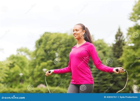 Smiling Woman Exercising With Jump Rope Outdoors Stock Image Image Of