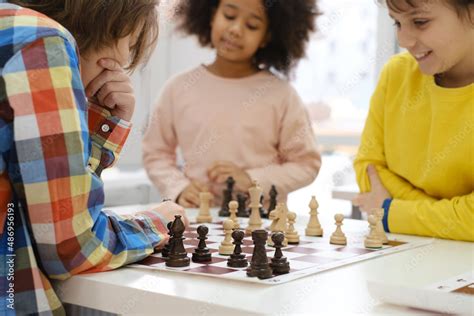 Diverse Group of kids playing chess. Concentrated multiethnic clever ...