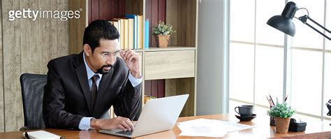 Adult Professional Businessman Wearing Glasses And Black Suit Sitting