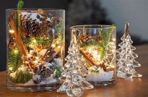 Two Glass Vases Filled With Pine Cones And Lights