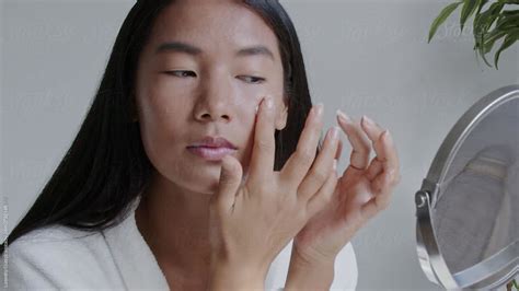 Woman Uses Skin Lotion By Stocksy Contributor Ohlamour Studio Stocksy