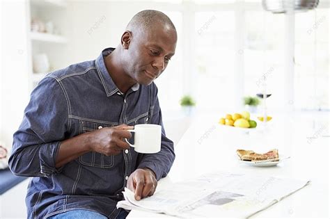 African American Man Eating Breakfast And Reading Newspaper Background