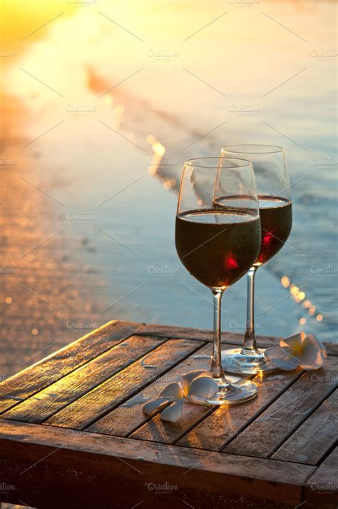 Romantic Beach Scene Two Glasses Of Red Wine At Sunset Near Water ~ Photos ~ Creative Market