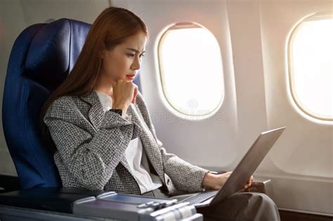 Professional Asian Businesswoman Travel by Airplane, Using Laptop ... 