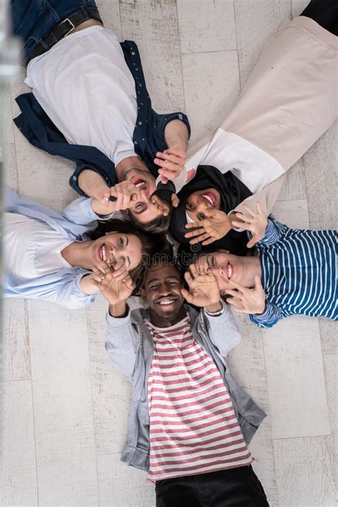 Top View Of A Diverse Group Of People Lying On The Floor And