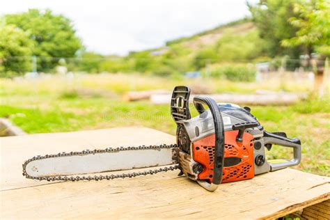 Chainsaw On A Wooden Table In A Garden Stock Photo Image Of Single