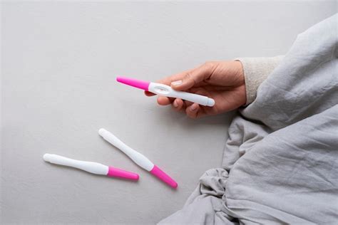 Premium Photo High Angle Woman Holding Positive Pregnancy Tests