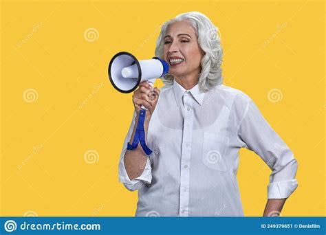 Portrait Of Cheerful Mature Businesswoman Talking Into Megaphone On