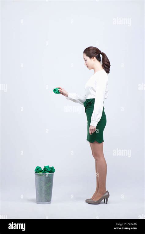 Woman Throwing Away Green Trash Into The Trashcan Stock Photo Alamy