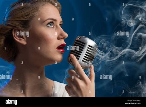 Attractive Female Singer With Microphone Stock Photo Alamy