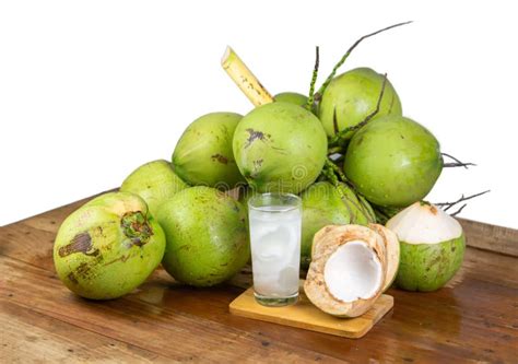 Fresh Coconut Juice With Its Meat And A Bunch Of Coconuts Stock Photo