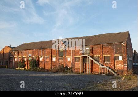 Old Abandoned Overgrown Factory With Rusty Remains Of Industrial