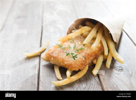 Fish And Chips Fried Fish Fillet With French Fries Wrapped By Paper