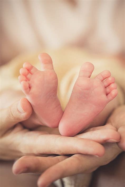 The Newborn S Legs In Gentle Hands Of Mother Stock Photo Image Of