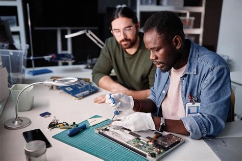 Premium Photo Two People Fixing Computer In Tech Repair