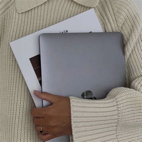 A Woman Holding Two Laptops In Her Hands