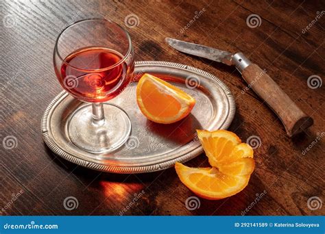 Sweet Wine With A Fresh Orange On A Dark Rustic Wooden Background Stock