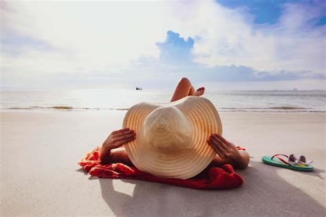 Premium Photo Man Relaxing On Beach Against Sky