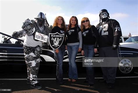 Oakland Raider fans in costumes pose during tailgate festivities ...