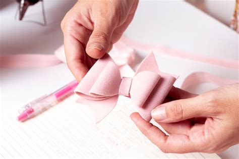 Premium Photo Woman39s Hands Holding A Bow Made Of Pink Leather