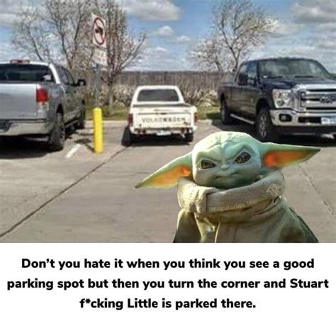 The Baby Yoda Is Standing In Front Of Two Trucks And Has An Interesting